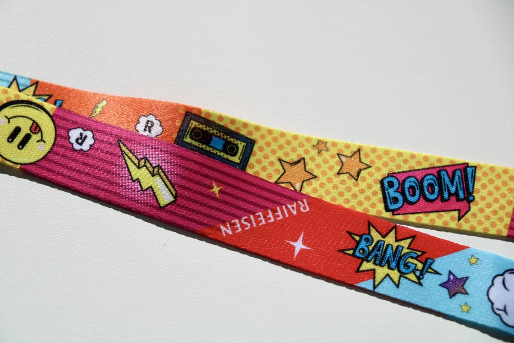 lanyard-imprime-raiffeisen-detail Détail d'un lanyard personnalisé Raiffeisen à imprimé pop art